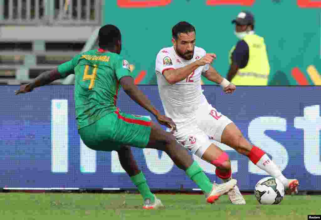 Mauritania's Harouna Abou Demba in action with Tunisia's Ali Maaloul; Cameroon, Jan. 16, 2022.