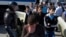 FILE - Police block a road out of Simferopol, Crimea, May 18, 2015, while young Tatars walk away during a march to mark the 71st anniversary of Soviet dictator Stalin's 1944 mass deportation of Crimean Tatars. 