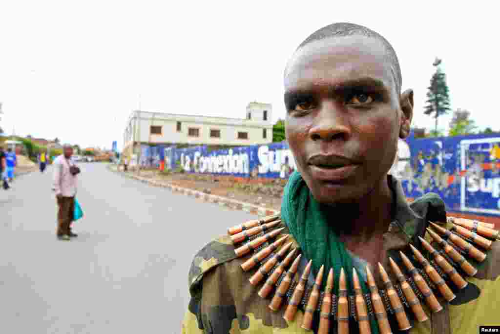 A Congolese Revolution Army rebel, wearing a belt of ammunition, walks down a street in Goma, DRC, soon after the rebels captured the city from the government army, November 20, 2012.