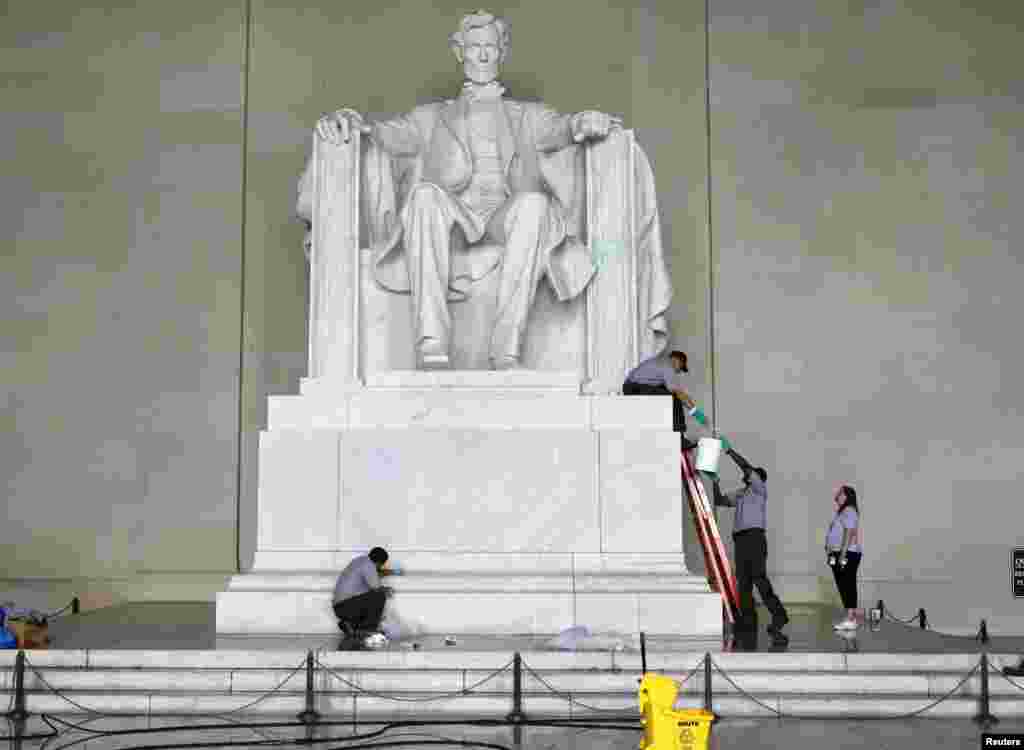 National Park Service employees clean green paint from the Lincoln Memorial in Washington, July 26, 2013.