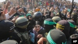 Israeli captive Arbel Yehoud, 29, who has been held hostage by Hamas in Gaza since Oct. 7, 2023, is escorted by Hamas and Islamic Jihad fighters as she is handed over to the Red Cross in Khan Younis, southern Gaza Strip, Jan. 30, 2025.