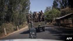 FILE - Soldiers with the Ethiopian National Defense Force (ENDF) travel on a truck near Aykel, on a road that connects Gondar to the Sudanese border in Ethiopia's Amhara region, on Feb. 27, 2024.