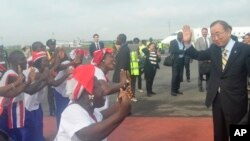 UN Secretary General Ban Ki-moon, is greeted by dancers upon arrival at the Roberts international airport in Monrovia, Liberia, Friday, Dec. 19, 2014.