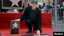 Ron Howard touches his star on the Hollywood Walk of Fame after being honored with the 2,568th star in Los Angeles, California, Dec. 10, 2015. 