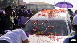 A woman cries as she leans on the hearse containing the coffin of late Suriname President Desi Bouterse during his funeral procession in downtown Paramaribo on Jan. 4, 2025. 