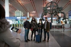 FILE - Wall Street Journal China Bureau Chief Jonathan Cheng, left, poses with Journal reporters, from left, Julie Wernau, Stephanie Yang, and Stu Woo before their departure at Beijing Capital International Airport in Beijing, March 28, 2020.