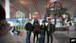 Wall Street Journal China Bureau Chief Jonathan Cheng, left, poses for a photo with Journal reporters, from left, Julie Wernau, Stephanie Yang, and Stu Woo before their departure at Beijing Capital International Airport in Beijing, March 28, 2020.