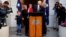 Former Australian prime minister Malcolm Turnbull kisses his wife, Lucy, while standing with daughter Daisy, and grandchildren Alice and Jack after a news conference in Canberra, Australia, Aug. 24, 2018. Turnbull resigned from Parliament Friday, triggering an election.