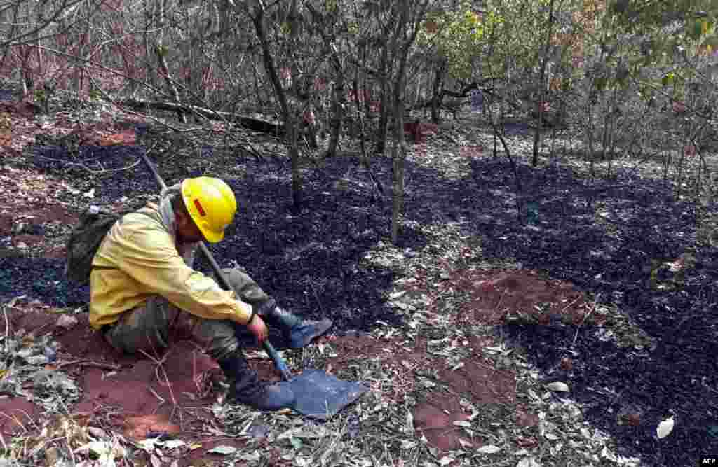 A fireman rests as he combats a fire in the surroundings of Robore in eastern Bolivia.