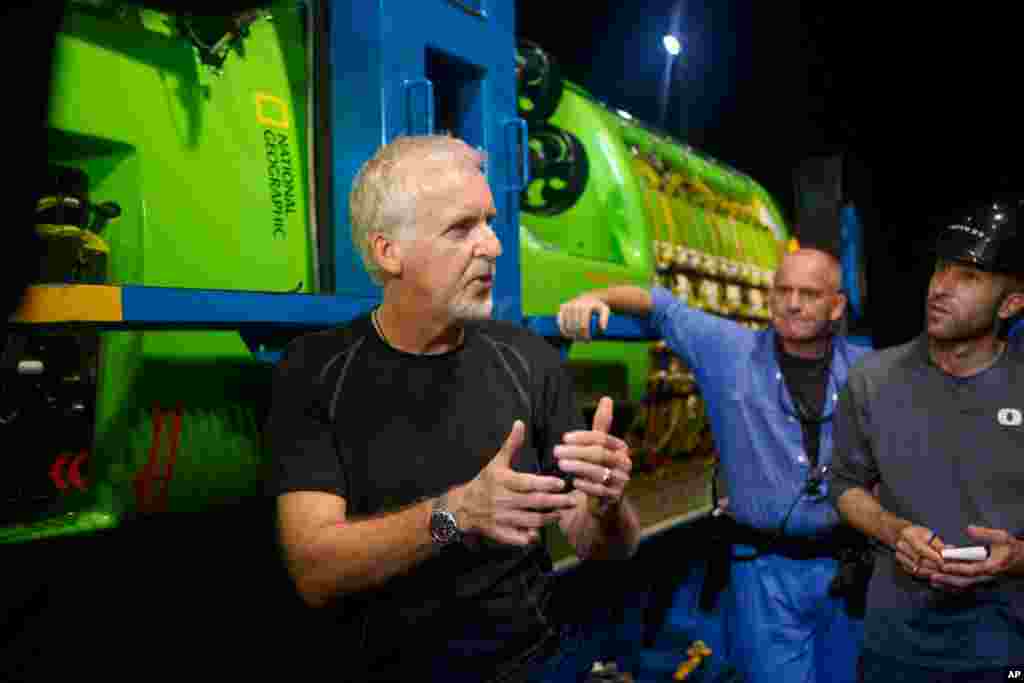James Cameron talks with his crew in front of the DEEPSEA CHALLENGER following testing of the submersible in Jervis Bay, south of Sydney, Australia. The submersible will travel to the bottom of the Mariana Trench as the centerpiece of DEEPSEA CHALLENGE, a