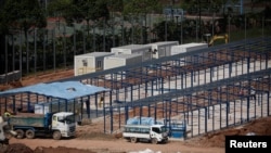 A general view of workers constructing 'quick-build' semi-permanent dormitories to house migrant workers amid the coronavirus disease .