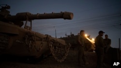 Beberapa tentara Israel berdiri di samping sebuah tank di Dataran Golan yang dicaplok Israel, 19 September 2024. (Foto: Leo Correa/AP Photo)