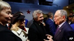 Democratic presidential candidate and former New York City Mayor Michael Bloomberg, right, meets with supporters during a campaign stop in Sacramento, Calif., Feb. 3, 2020. 