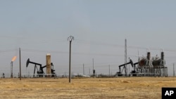 FILE - An oil field controlled by the Kurdish-led Syrian Democratic Forces (SDF) is seen northeast Syria, July 30, 2017.