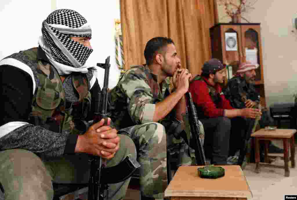 Free Syrian Army fighters attend a meeting with their commander to discuss new military strategies inside their headquarters in Raqqa province, Syria, May 13, 2013. 