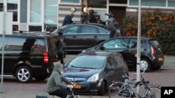 FILE - 37-year-old Gokmen Tanis is led away by police in Utrecht, Netherlands, March 18, 2019, after a shooting incident on a tram. 