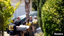 ATF and FBI agents approach the scene of the Santa Clara Valley Transportation Authority mass shooting suspect's house, after a fire at the home of the suspect erupted at about the same time as the shooting, in San Jose, California, May 26, 2021.