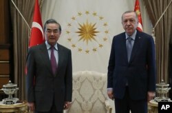 Turkey's President Recep Tayyip Erdogan, right, and Chinese Foreign Minister Wang Yi pose for a photo before a meeting, in Ankara, Turkey, March 25, 2021.