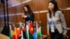 Workers stand behind a box with national flags of African nations during a press conference led by Chinese Foreign Minister Wang Yi and his counterparts, Senegal’s Yassine Fall and Congo's Jean-Claude Gakosso during the Forum on China-Africa Cooperation in Beijing, Sept. 5, 2024.