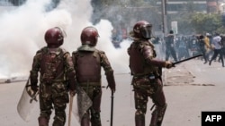 Kenya police officers are seen during an anti-government demonstration over tax hikes and a controversial now-withdrawn tax bill in downtown Nairobi, on July 2, 2024.