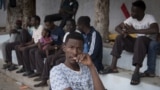 Sudanese refugees, who fled from the clashes between forces loyal to the internationally recognized Government of National Accord and forces loyal to strongman Khalifa Haftar, sit together at a school in Libya's capital, Tripoli, on April 24, 2019.