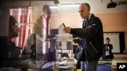 A voter casts his vote at a polling station in Sofia, April 2, 2023.