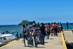 Stranded migrants from Cuba, Haiti and Africa arrive in Capurgana near the border with Panama, Colombia, July 31, 2021.