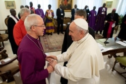 FILE - Pope Francis meets the Archbishop of Canterbury Justin Welby at the end of a two-day spiritual retreat with South Sudan leaders at the Vatican, April 11, 2019.