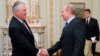 Russian Prime Minister Vladimir Putin, right, shakes hands with Rex W. Tillerson, chairman and chief executive officer of Exxon Mobil Corporation at their meeting in the Novo-Ogaryovo residence outside Moscow, Monday, April 16, 2012. Exxon is teaming up w