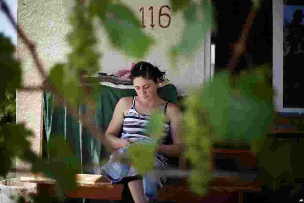 Thea Kristesyashvili, 29, on her porch in Karaleti. (Yuli Weeks for VOA)