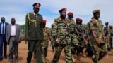 FILE - South Sudan's President Salva Kiir, center, and newly appointed army chief of staff Lt. Gen. James Ajongo Mawut, right, attend a ceremony marking the 34th anniversary of the Sudan People's Liberation Army in Juba, South Sudan, May 18, 2017..