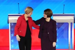 (L-R) Democratic presidential candidates Sen. Elizabeth Warren (D-MA) and Sen. Amy Klobuchar (D-MN) greet each other prior to the start of the Democratic presidential primary debate on Feb. 7, 2020.