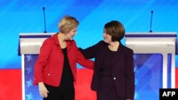 FILE - Democratic presidential candidates Sen. Elizabeth Warren and Sen. Amy Klobuchar greet each prior to the start of the Democratic presidential primary debate in the Sullivan Arena at St. Anselm College, Feb. 07, 2020, in Manchester, N.H.