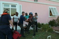 Members of U.S. Coast Guard evacuate a man from a hospital in Marsh Harbor, Abaco Island, Bahamas, Sept. 6, 2019.