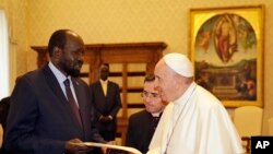 FILE - Pope Francis exchanges gifts with South Sudan President Salva Kiir during a private audience at the Vatican, March 16, 2019.