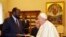 FILE - Pope Francis exchanges gifts with South Sudan President Salva Kiir during a private audience at the Vatican, March 16, 2019.