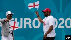 English football fans cheer outside of Wembley stadium in London, July 9, 2021. The Euro 2020 soccer championship final match between Italy and England will be played at Wembley stadium on Sunday.