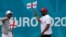 English football fans cheer outside of Wembley stadium in London, July 9, 2021. The Euro 2020 soccer championship final match between Italy and England will be played at Wembley stadium on Sunday.