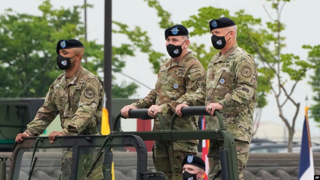 FILE - Incoming commander, Gen. Paul J. LaCamera, right, and outgoing commander, Gen. Robert B. Abrams, center, inspect the troops during a change-of-command ceremony in Pyeongtaek, South Korea, July 2, 2021.