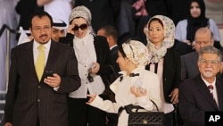 Dr. Ali al-Ekri, left, Dr. Nada Dhaif, center, Dr. Fatima Haji, 3rd right, and Dr. Saeed Samaheeji, right, leave the Manama, Bahrain, courthouse after a trial session appealing security court convictions and sentences against them and other medics, Janua