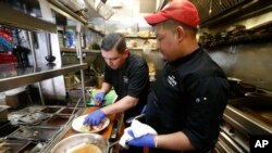 Staff at Martin's Tavern prepares a dish of corn beef and cabbage at Martin's Tavern in Washington, D.C., March 17, 2020.