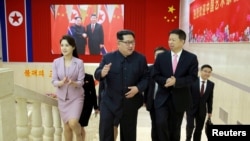 North Korean leader Kim Jong Un (center) meets Song Tao (right), the head of the China's Communist Party's International Department who led a Chinese art troupe to North Korea for the April Spring Friendship Art Festival, in this handout photo released by North Korea's Korean Central News Agency (KCNA) April 15, 2018.