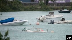 Swamped boats sit in Mullet Bay after the passing of Hurricane Nicole in St. Georges, Bermuda, Oct. 13, 2016. Hurricane Nicole roared across Bermuda, pummeling the resort island with winds that snapped trees and peeled off roofs before the storm spun away out to sea.