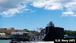 In this photo provided by U.S. Navy, the Virginia-class fast-attack submarine USS Illinois (SSN 786) returns home to Joint Base Pearl Harbor-Hickam from a deployment in the 7th Fleet area of responsibility on Sept. 13, 2021.