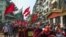 Buddhist monks and demonstrators rally against the military coup and to show their support to local residents after riot police officers used teargas to disperse a crowd that held a protest the night before in Yangon's Tamwe neighborhood
