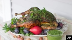 Roasted turkey is a traditional dish shared by family and friends at Thanksgiving. However, this year Thanksgiving celebrations will probably be much smaller. This Sept. 29, 2014, photo shows herb roasted Thanksgiving turkey in Concord, New Hampshire. (AP Photo/Matthew Mead)