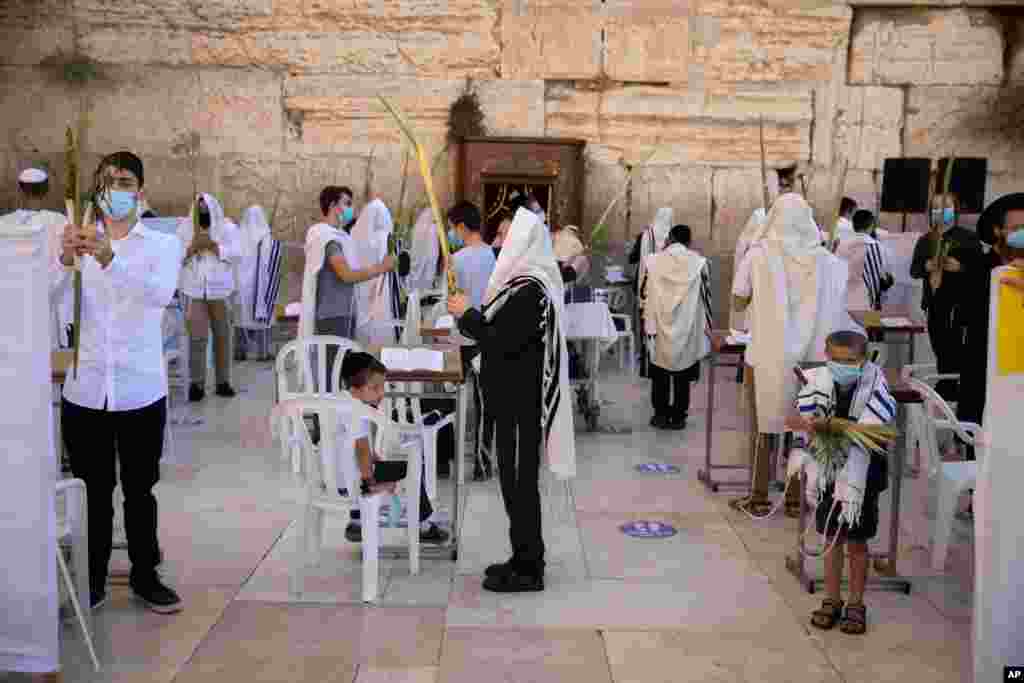 An ultra-Orthodox Jewish man prays during the Jewish holiday of Sukkot at the Western Wall, the holiest site where Jews can pray in Jerusalem&#39;s Old City.