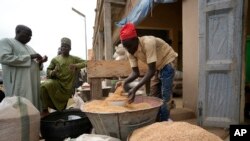 FILE - A man sells grain in Dawanau International Market in Kano Nigeria, Friday, July 14, 2023. Nigeria introduced programs before and during Russia's war in Ukraine to make Africa's largest economy self-reliant in wheat production.