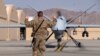 A U.S. airman guides a U.S. Air Force MQ-9 Reaper drone as it taxis to the runway at Kandahar Airfield, Afghanistan, March 9, 2016. 