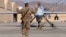 A U.S. airman guides a U.S. Air Force MQ-9 Reaper drone as it taxis to the runway at Kandahar Airfield, Afghanistan, March 9, 2016. 